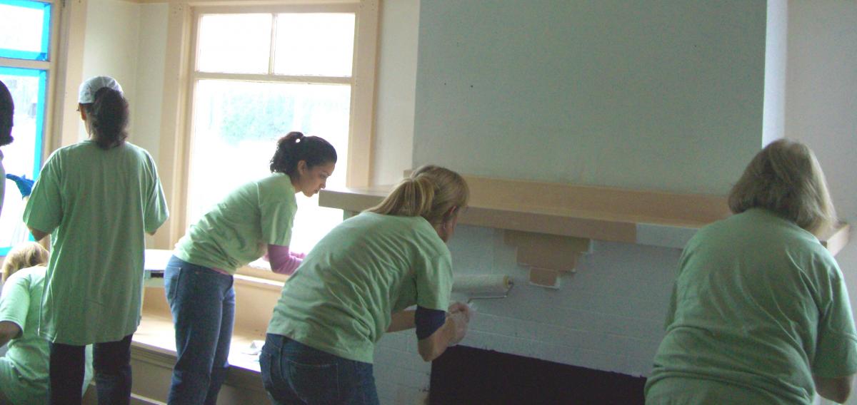 Volunteers help paint a house Volunteers help paint a house